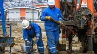 Workers mount a pump jack at Bibi Heybat Oil Field in Azerbaijan (Getty)