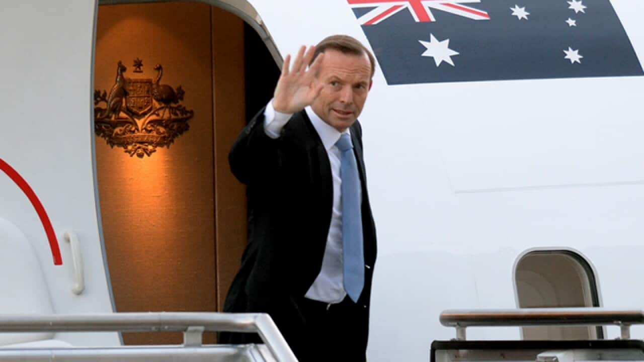 Prime Minister Tony Abbott boards a flight to India in Canberra