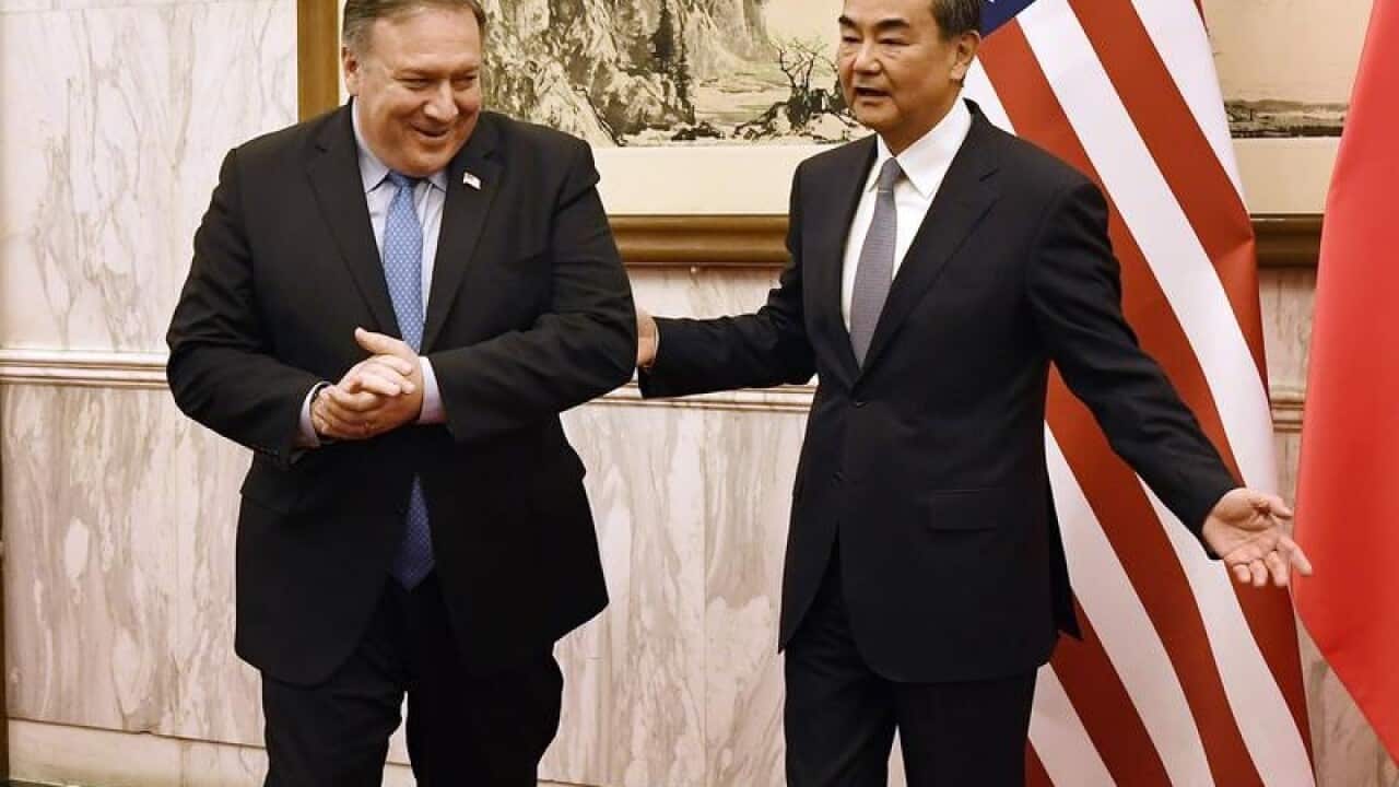 A file image of Mike Popmeo and Wang Yi