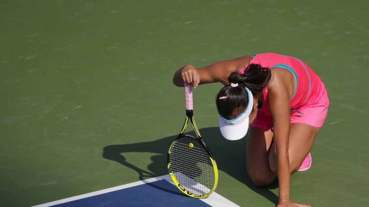 Peng Shuai of China kneels on the court