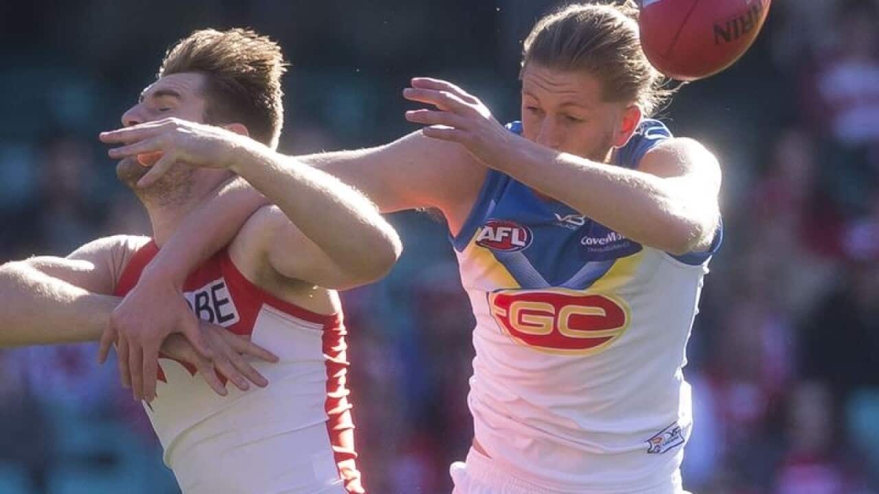 Harry Marsh of the Swans and Aaron Young of the Suns contest a mark.