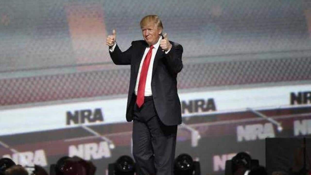 President Donald Trump gestures after speaking at the National Rifle Association-ILA Leadership Forum