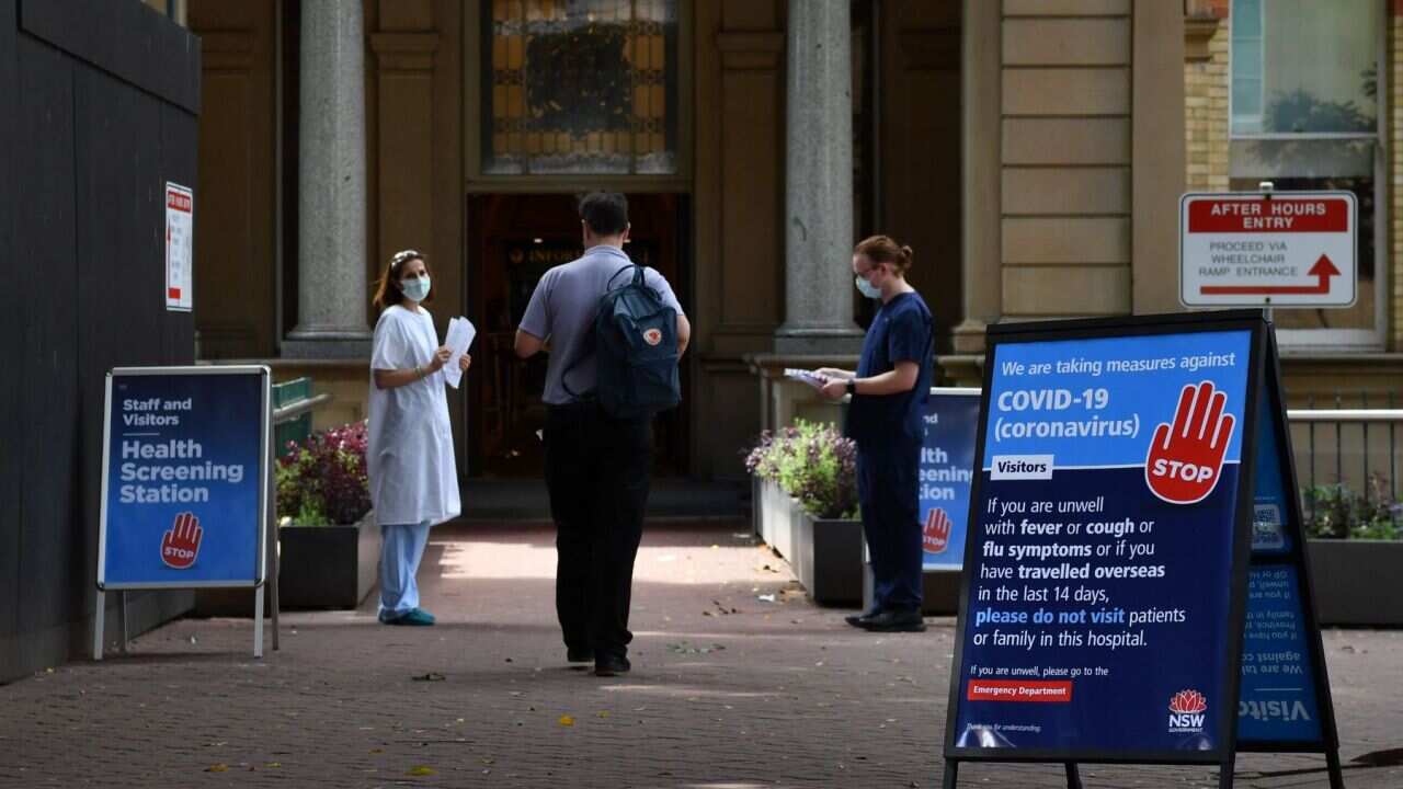 Staff wearing face masks outside the Royal Prince Alfred Hospital (RPA) in Camperdown, Sydney, Wednesday, March 25, 2020