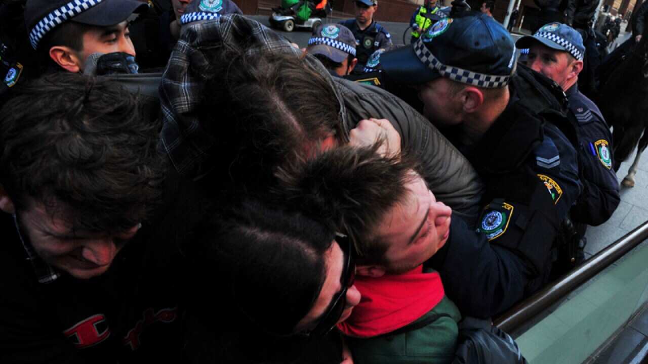 Protesters are pushed back by NSW Police