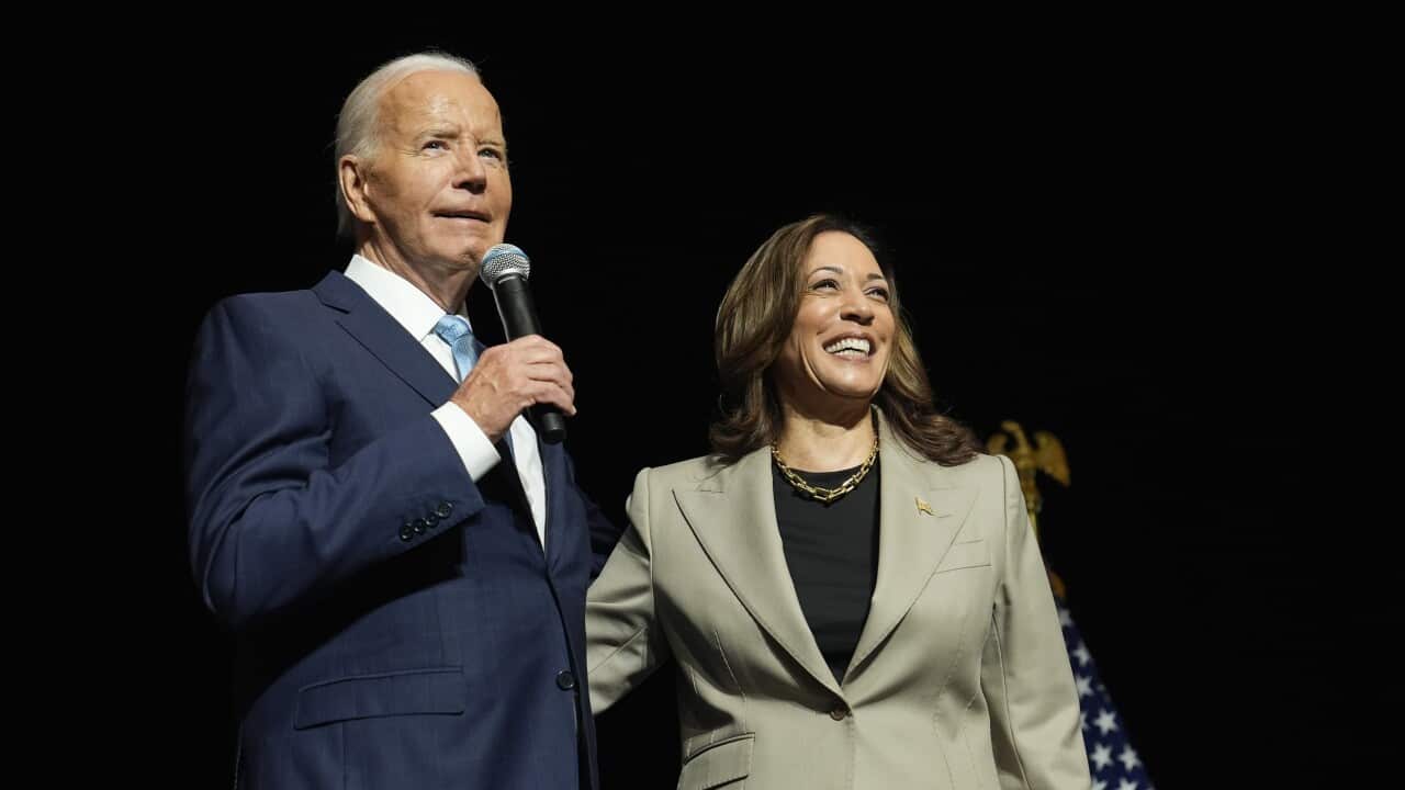Joe Biden and Kamala Harris on stage speaking.
