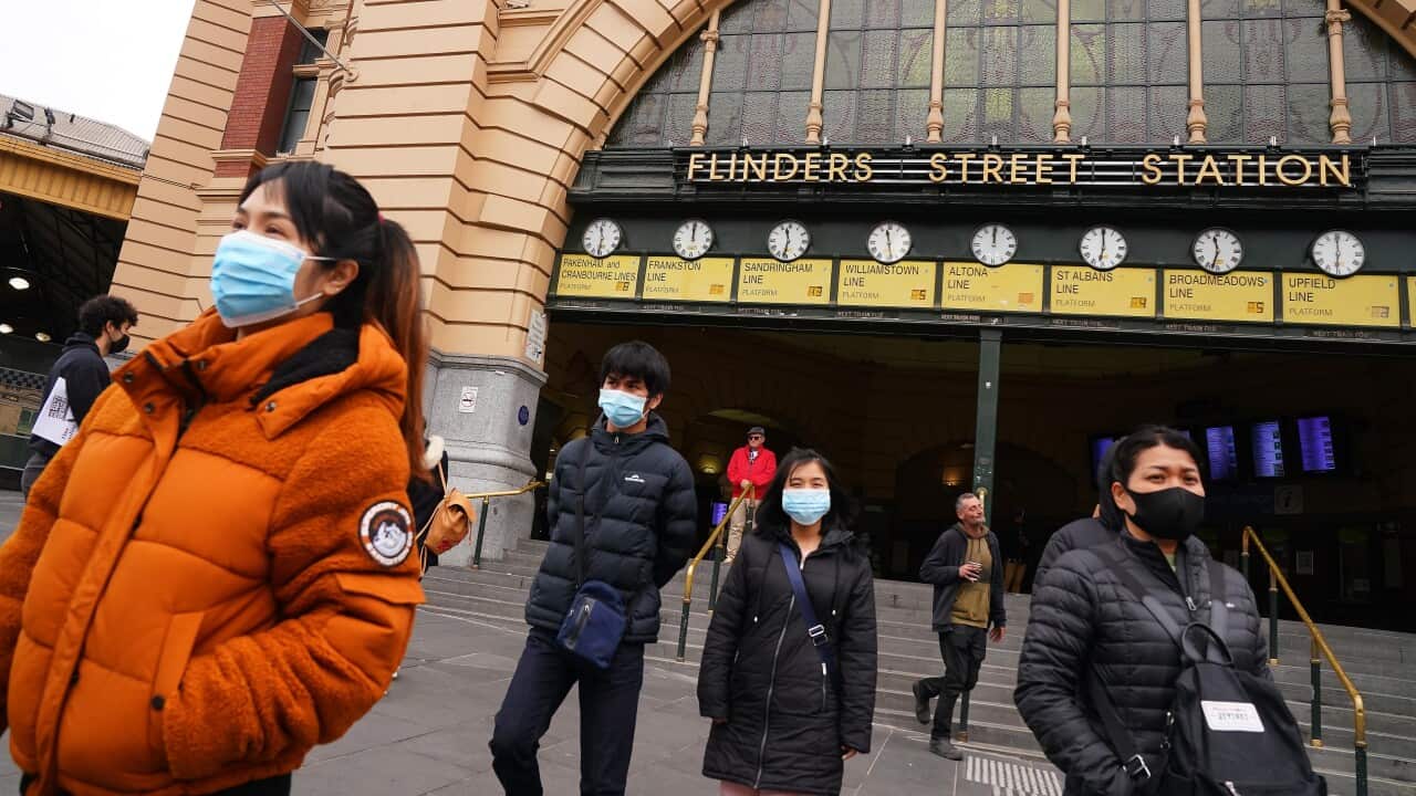 People leave Flinders Street Station while while wearing face masks as a preventive measure against the spread of novel coronavirus COVID-19.