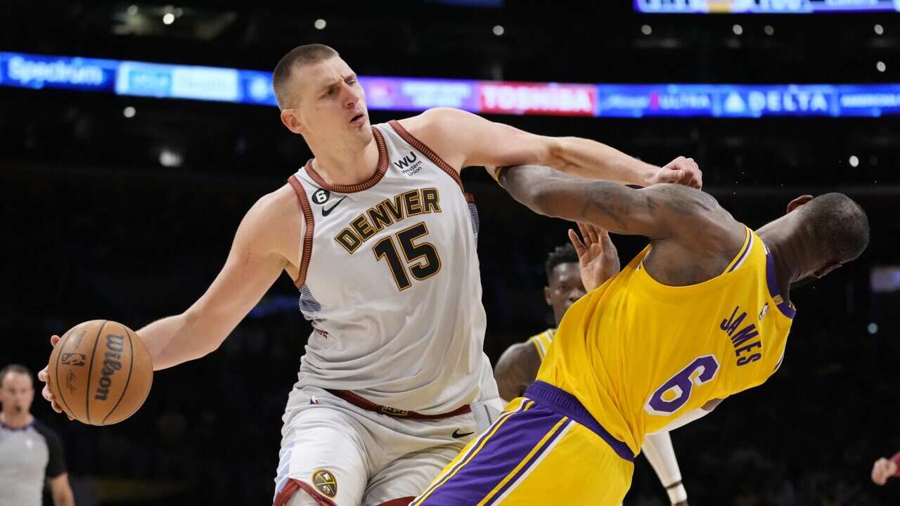 Denver Nuggets center Nikola Jokic (15) collides with Los Angeles Lakers forward LeBron James (6) in the second half of Game 4 of the NBA basketball Western Conference Final series