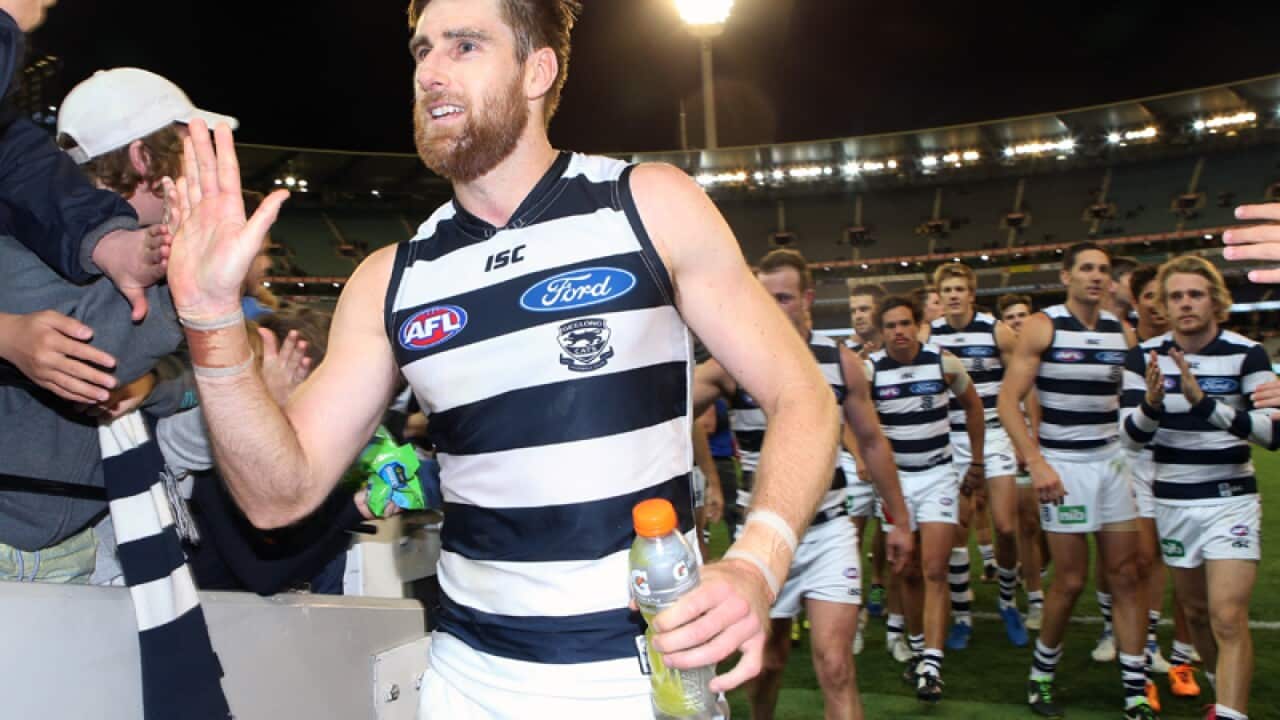 Tom Lonergan leads Geelong off the field