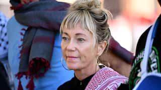 A blonde woman wearing a red and white keffiyeh