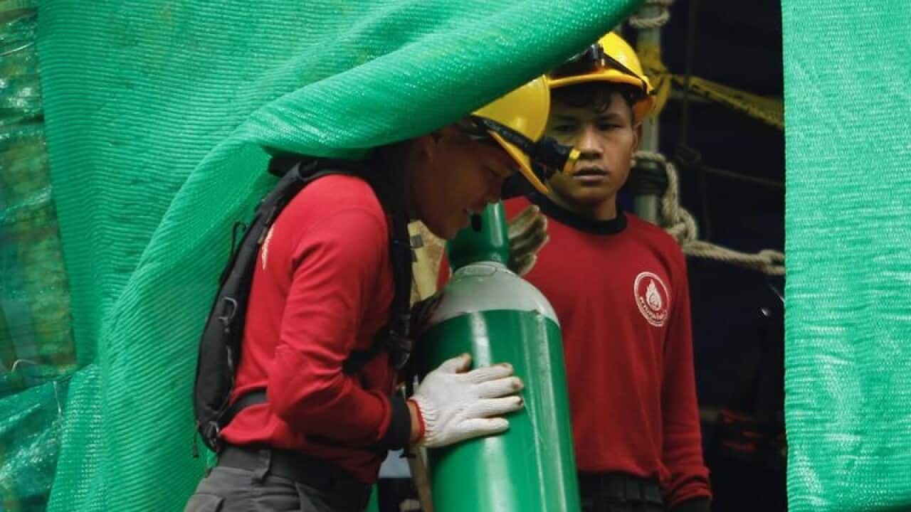Thai workers preparing oxygen tanks
