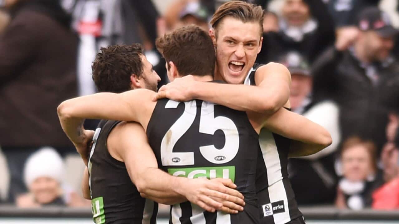 Jack Crisp of the Magpies celebrates his goal with Darcy Moore