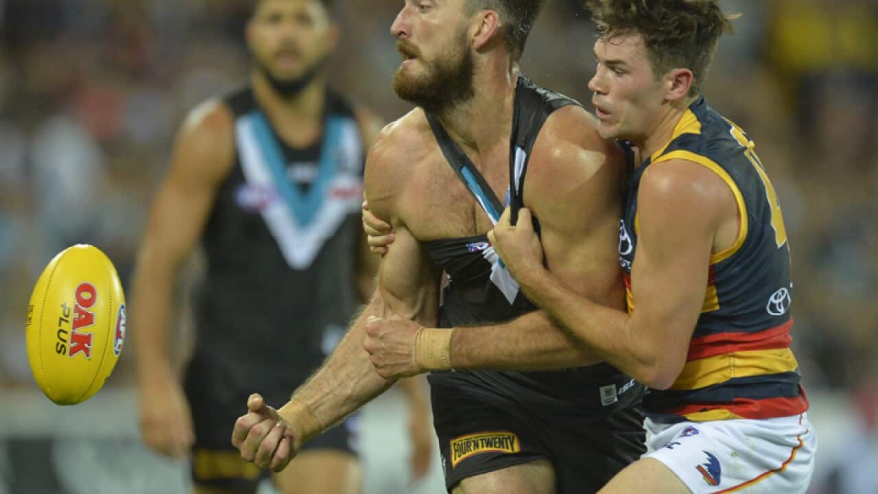 Charlie Dixon of the Power (L) and Mitch McGovern of the Crows