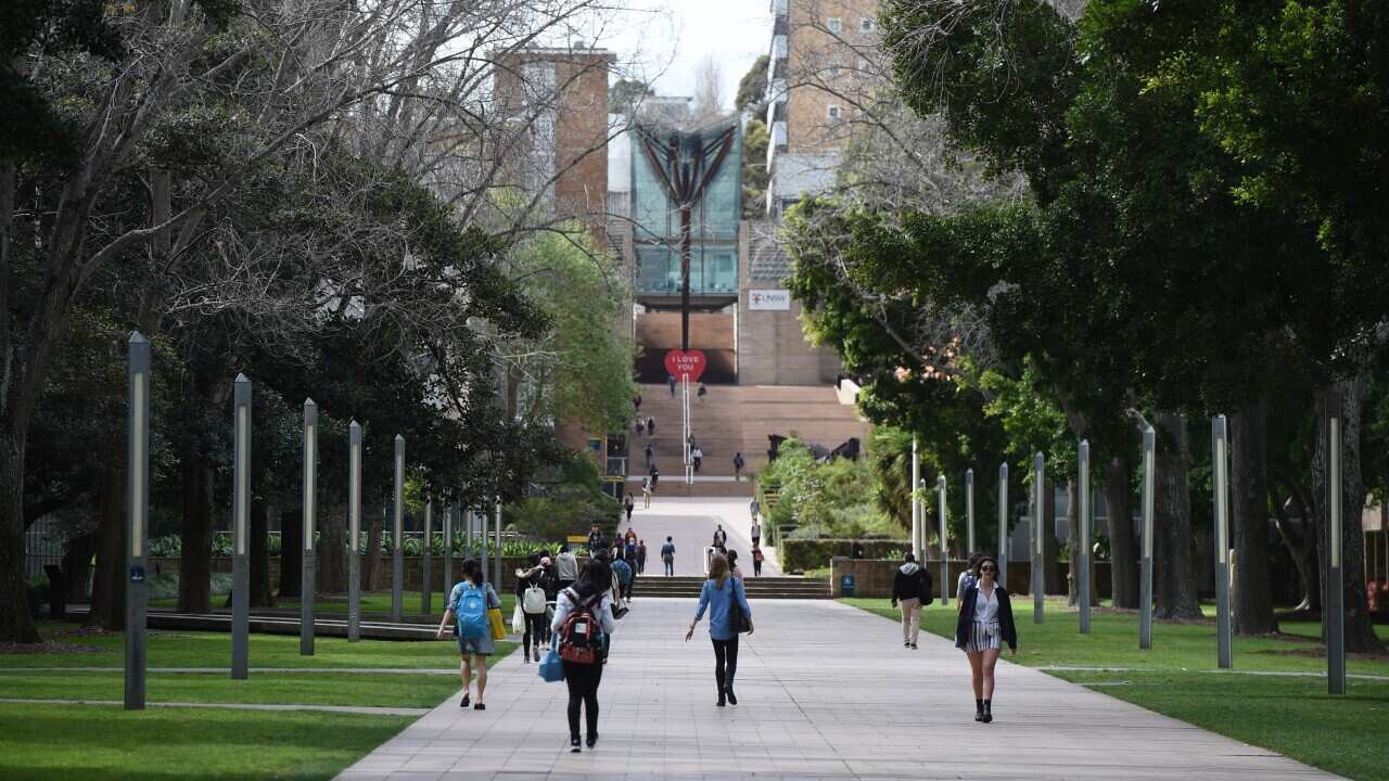 Students walking through the grounds of a university.