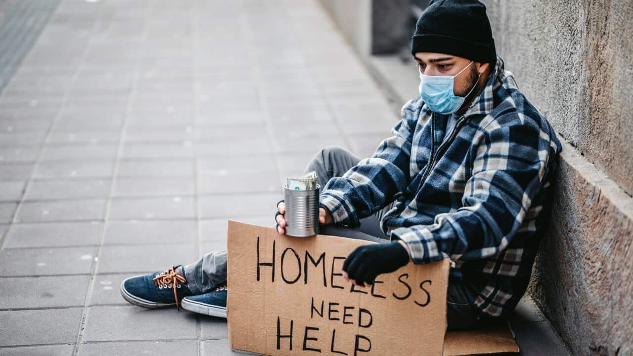 Homeless man sitting and begging for help