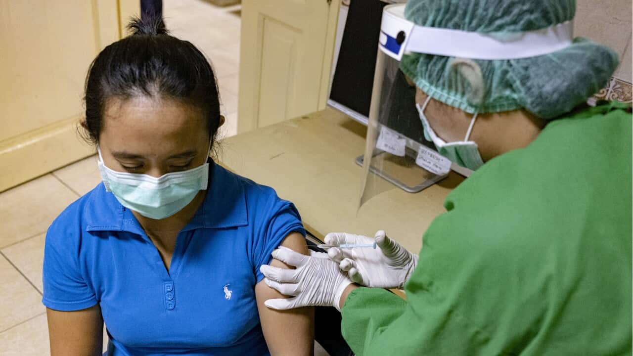 A medical worker takes part in a vaccine drill in Indonesia
