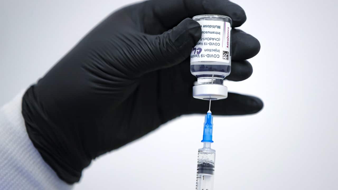 A doctor with an AstraZeneca vaccine container at a vaccination center in Bucharest, Romania