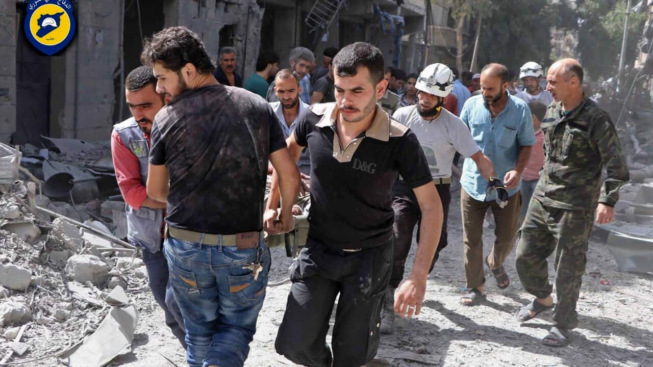 Rescue workers work the site of airstrikes in al-Mashhad neighborhood in the rebel-held part of eastern Aleppo, Wednesday Sept. 21, 2016