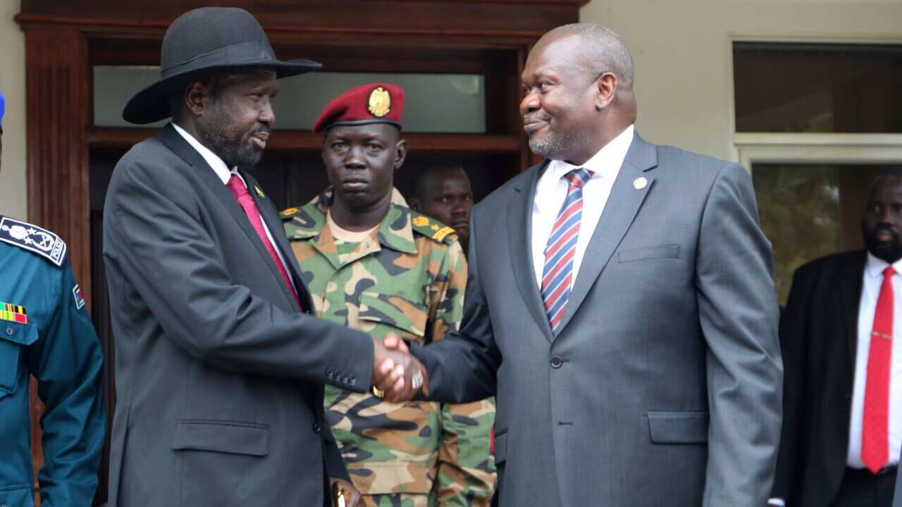 South Sudan's President Salva Kiir left, and opposition leader Riek Machar, right, shake hands after meetings in October (AAP)