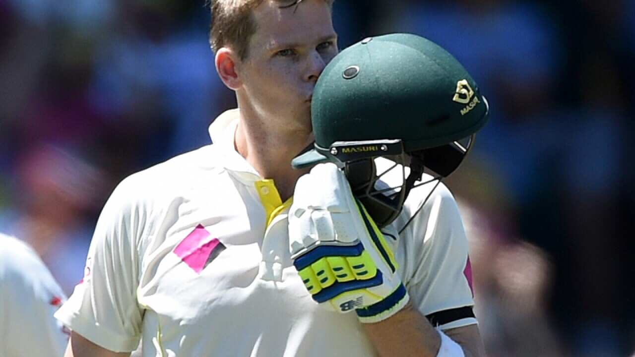 Steve Smith kisses his helmet upon scoring 100 runs