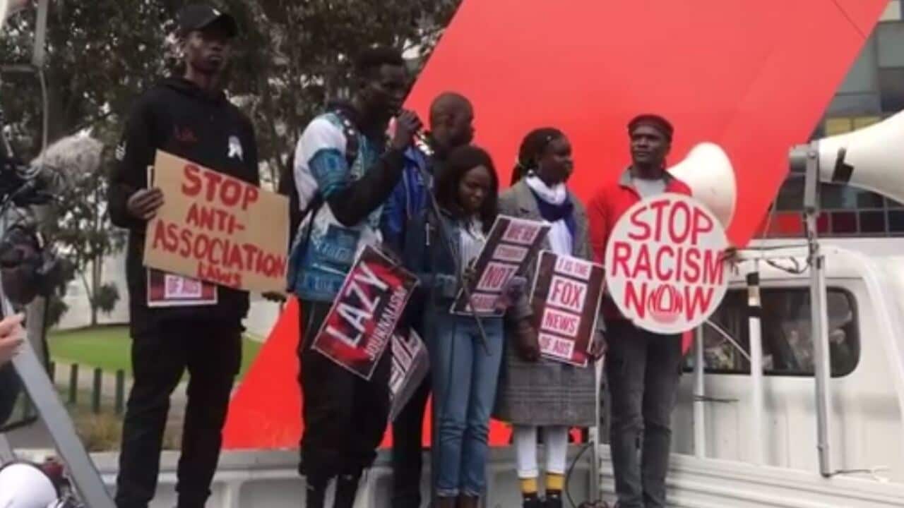 Protest organisers address the crowd outside Channel 7's office in Melbourne.