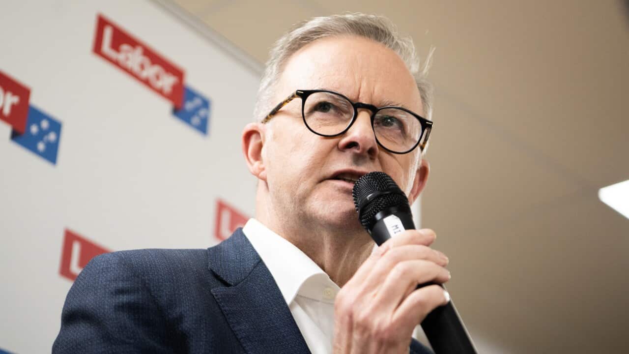 Prime Minister Anthony Albanese speaks into a microphone in his hand