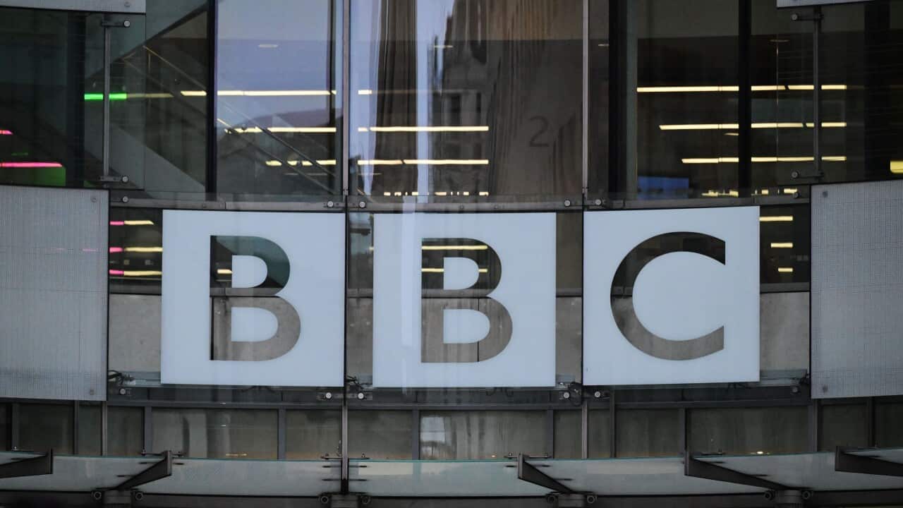 Glass windows of BBC offices with the logo on them