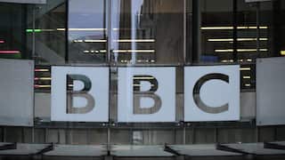 Glass windows of BBC offices with the logo on them