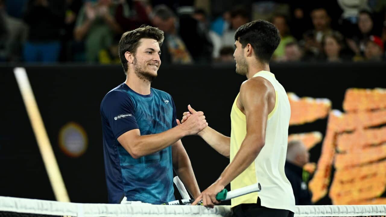Miomir Kecmanovic of Serbia congratulates Carlos Alcaraz of Spain during his 4th round win on Day 9 of the 2024 Australian Open at Melbourne Park in Melbourne