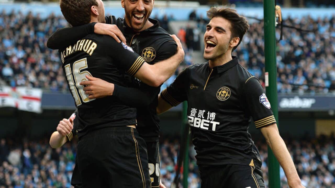 Wigan's James Perch (C) is congratulated after scoring