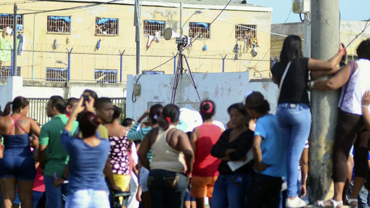 Relatives wait for news at the jail in Barranquilla