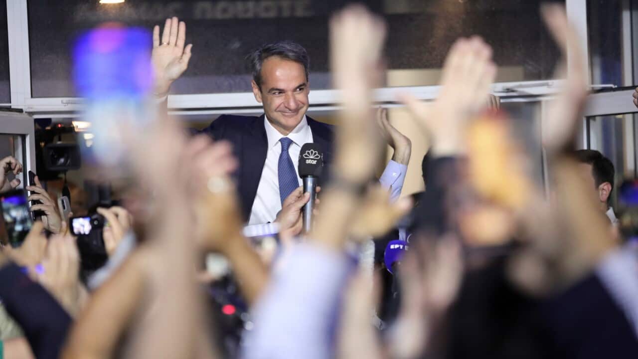 Greek PM Kyriakos Mitsotakis greets supporters after the announcement of the general election results