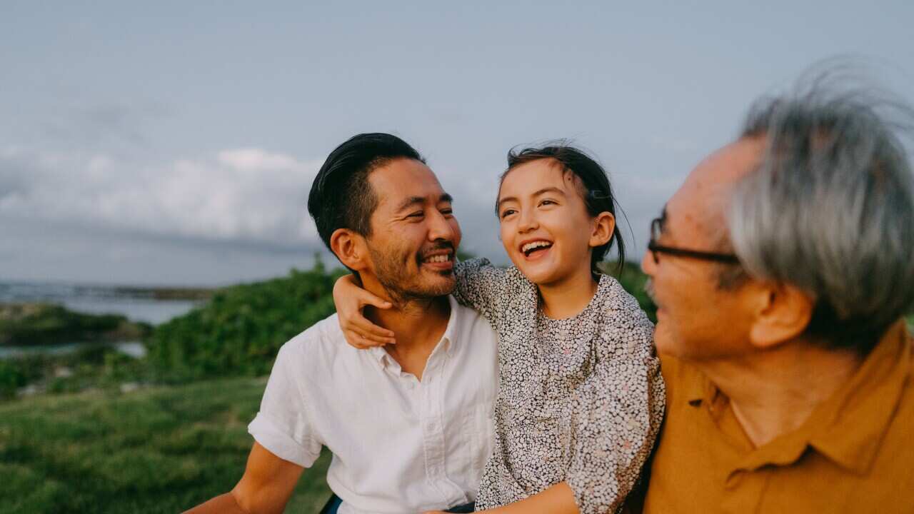 Three generation family having a good time at dusk