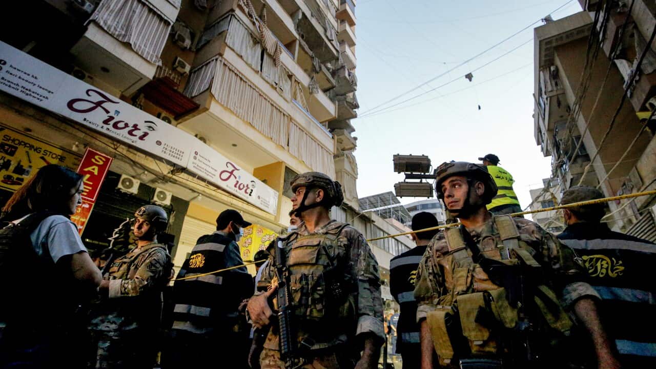 Lebanese army soldiers secure the site where an Israeli raid destroyed two apartments in a building in Beirut