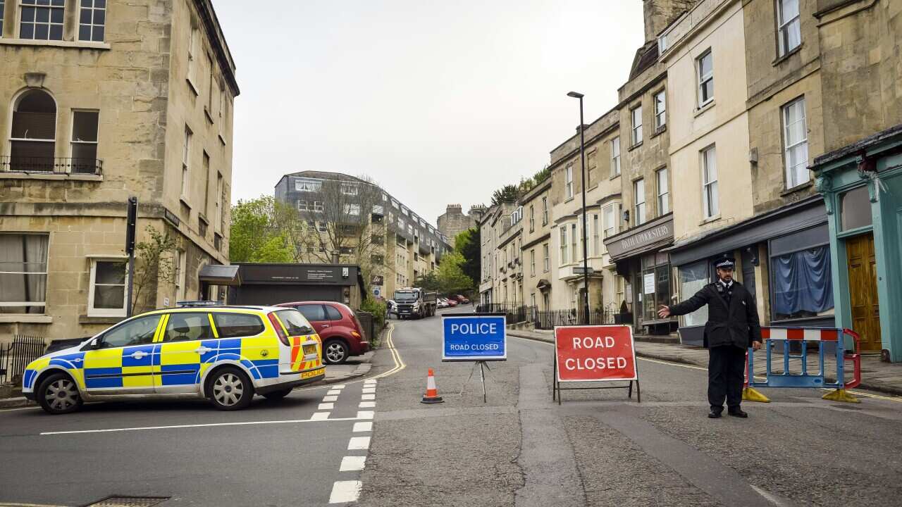 Police divert away traffic from an exclusion zone set up after contractors unearthed a Second World War shell in Bath, England.