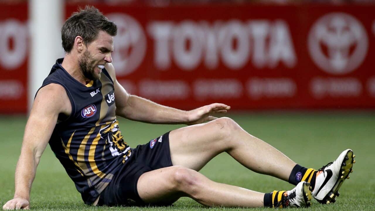 Chris Newman of the Tigers grimaces with an injury