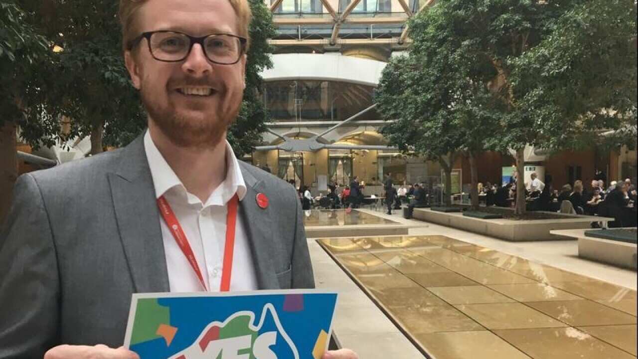 British Labour MP, Lloyd Russell-Moyle holds a yes campaign sign.