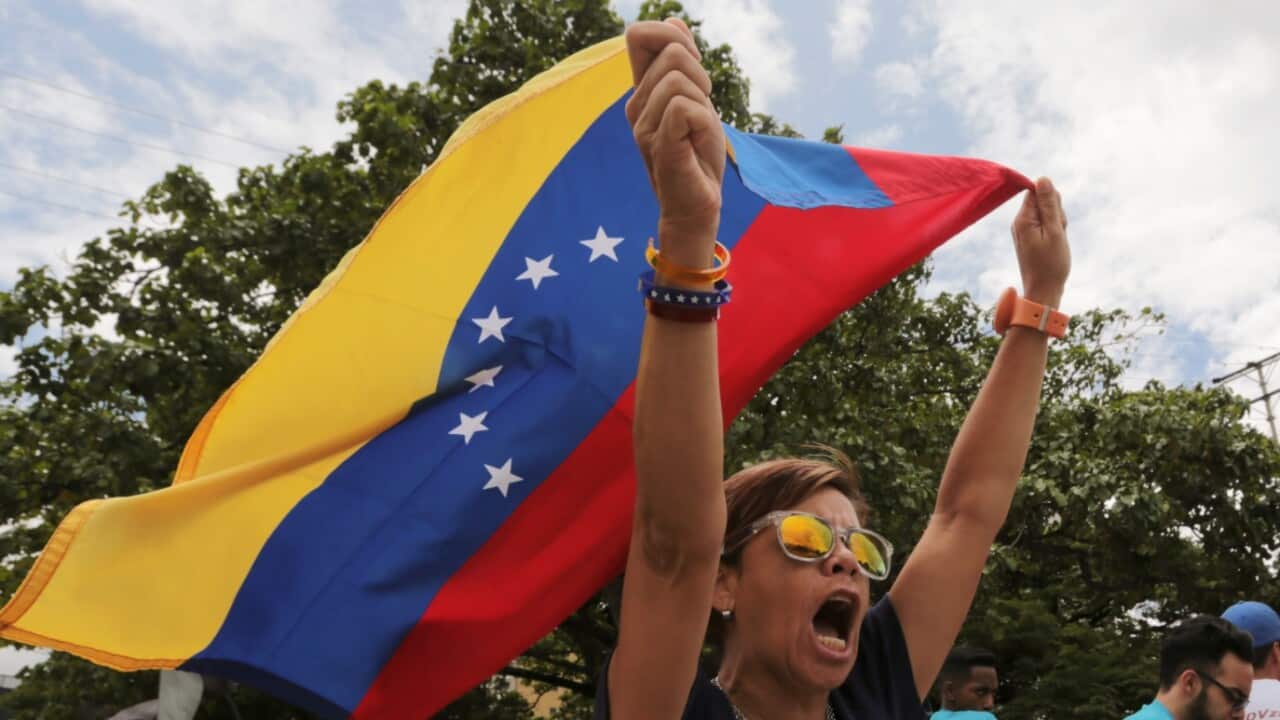 Opponents of Venezuelan President Nicolas Maduro protest the previous day's presidential election which Maduro won