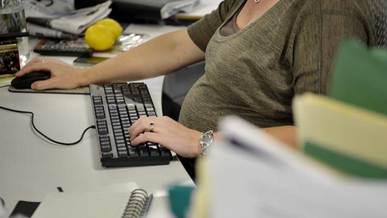 A pregnant lady at work.