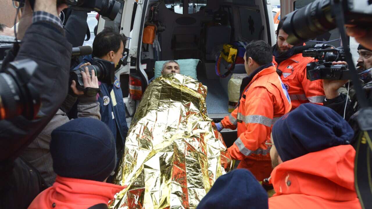 Rescuers assist a passenger of the Italian-flagged Norman Atlantic