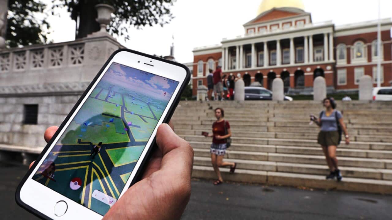 A Pokemon Go player outside the Massachusetts Statehouse in Boston