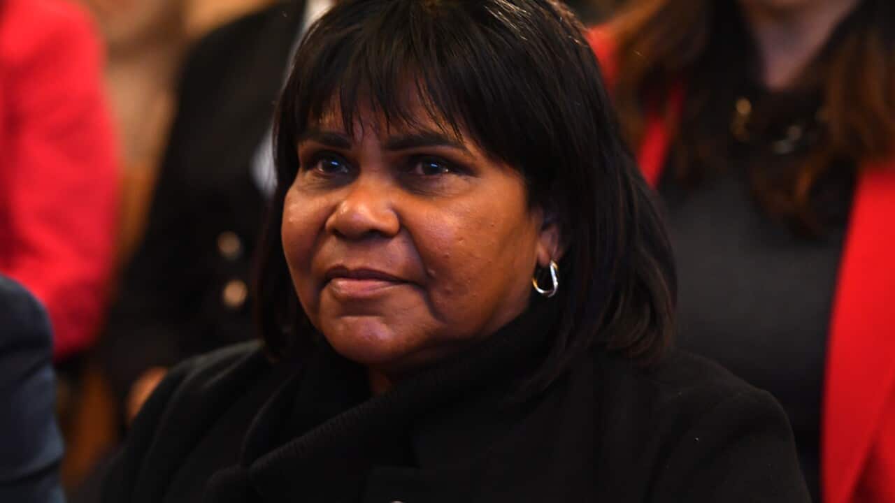 A woman in a black outfit.