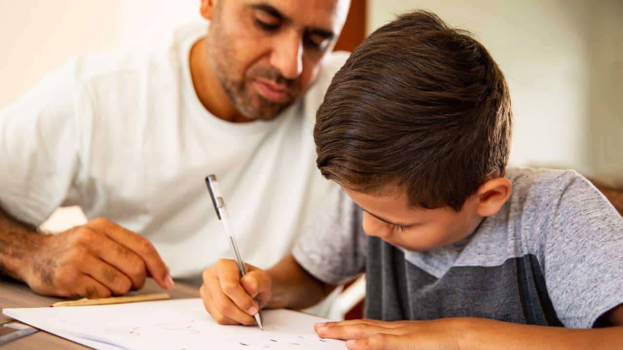 Father and son working on homework
