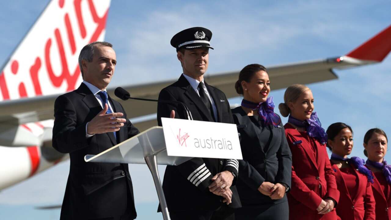 Virgin Australia CEO John Borghetti (L) with cabin staff