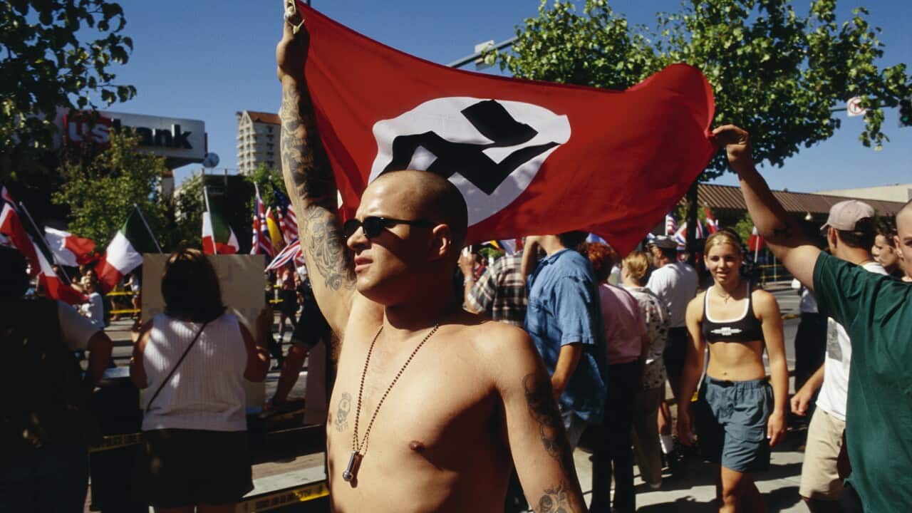 Aryan Nations Member Holding Nazi Flag
