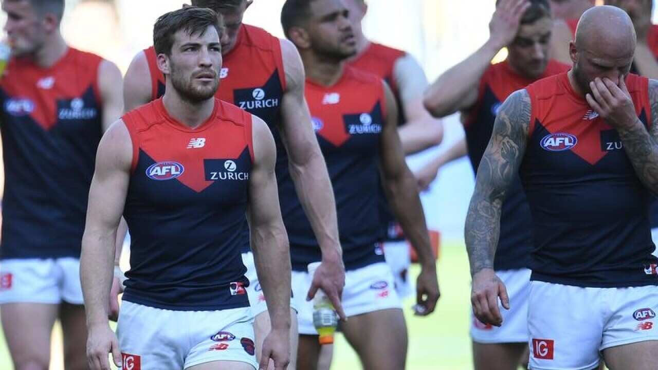 Melbourne players leave the field