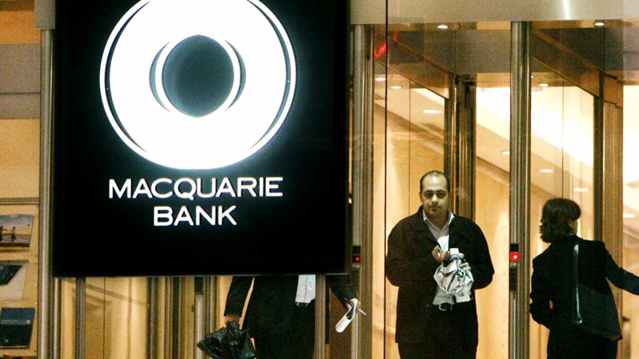 People move about in the lobby of the Sydney offices of Macquarie Bank