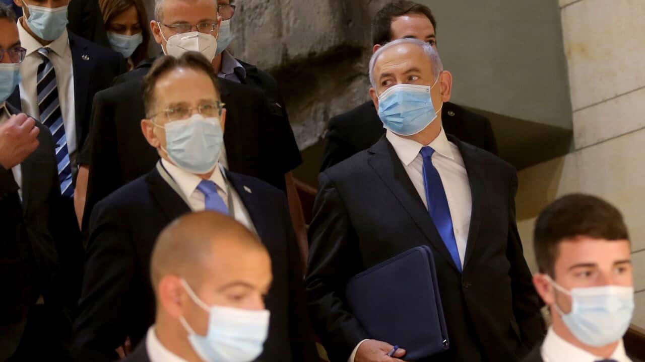 epa08427707 Israeli Prime Minister Benjamin Netanyahu (C) wearing a protective face mask on his way to attend the swearing in ceremony of the new government, at the Knesset (parliament) in Jerusalem, Israel, 17 May 2020. EPA/ALEX KOLOMIENSKY / POOL POOL