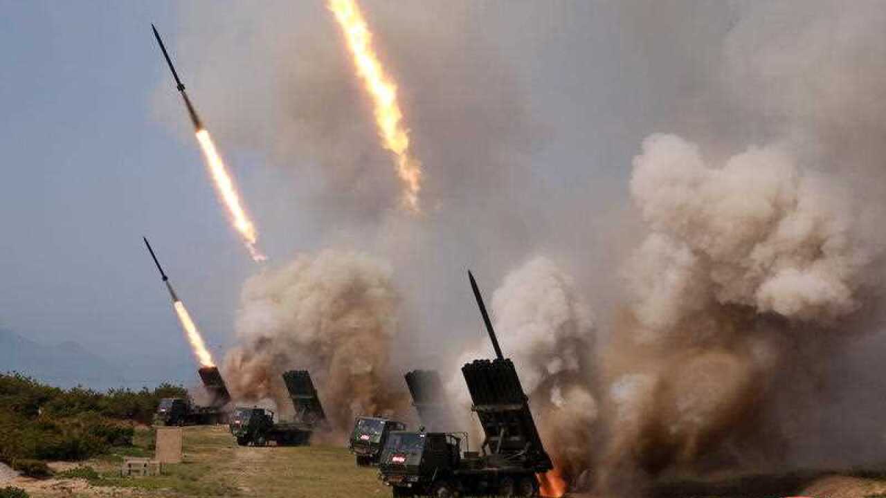 A photo released by the official North Korean Central News Agency (KCNA) shows North Korean rocket launchers firing during a 'strike drill'.