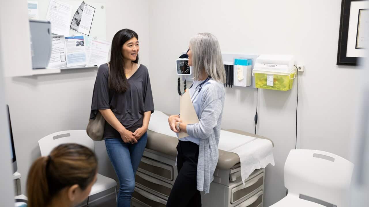 A patient talking with her doctor