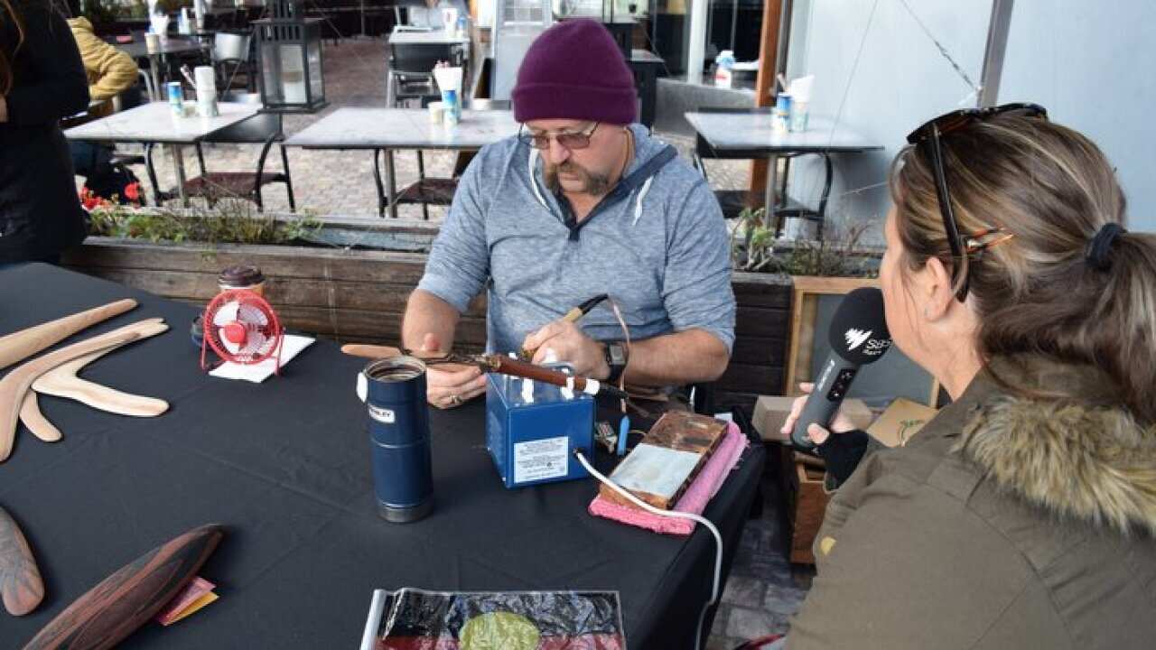 Mick Harding demonstrating wood burning techniques
